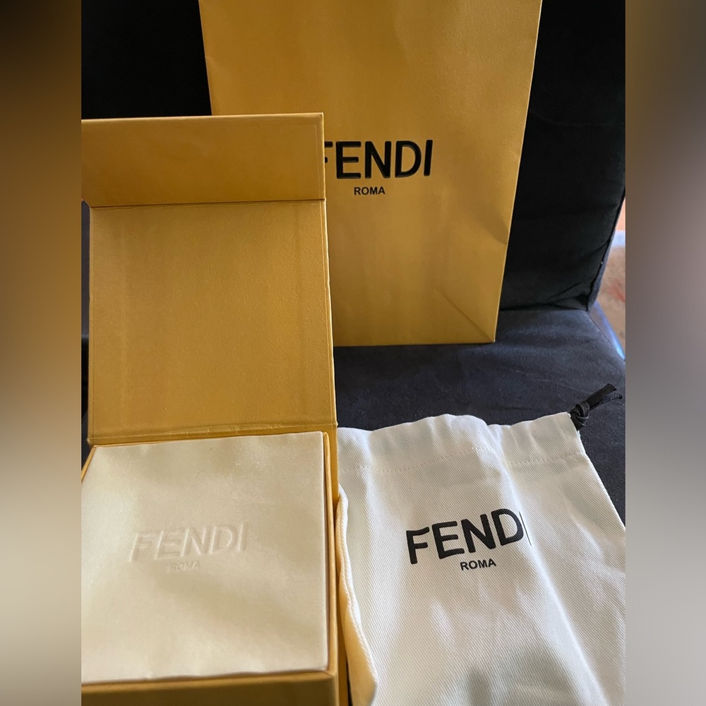 Authentic Fendi 3xm hoop earrings with Fendi cutout logo.